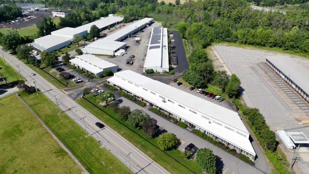 Aerial view of the five Concord Business Center buildings, shared parking and Hall Street